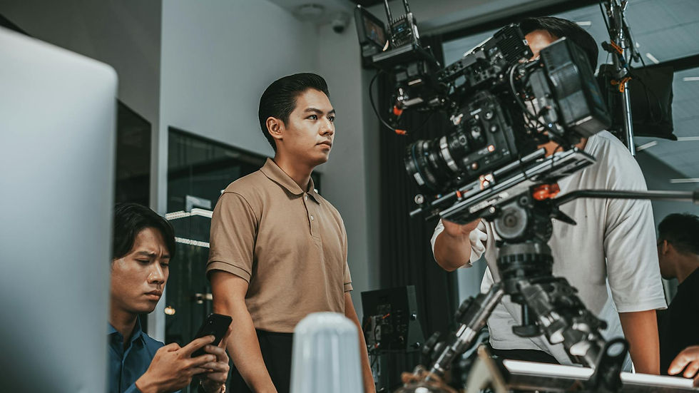 Film crew working with advanced camera equipment indoors, focusing on a project.