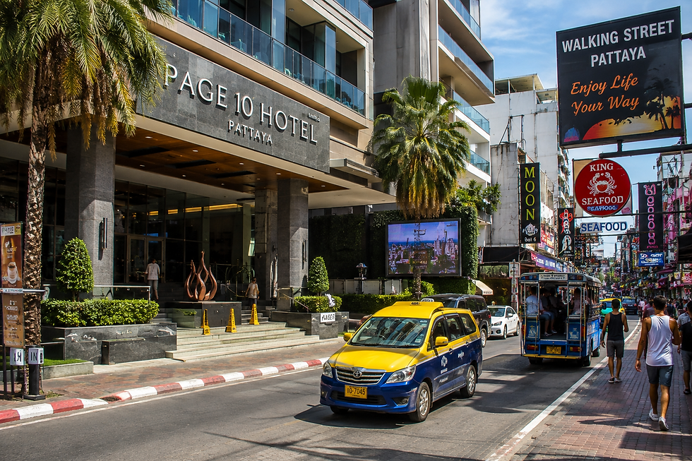 Hotel near Walking Street Pattaya with palm trees and city streets