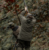 Person aiming a long gun, another person nearby Walking Gun Photography image of Grouse shooting Hughes & Co