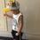 Thumbnail: Young child wearing a yellow cartoon baseball cap and white sleeveless shirt.