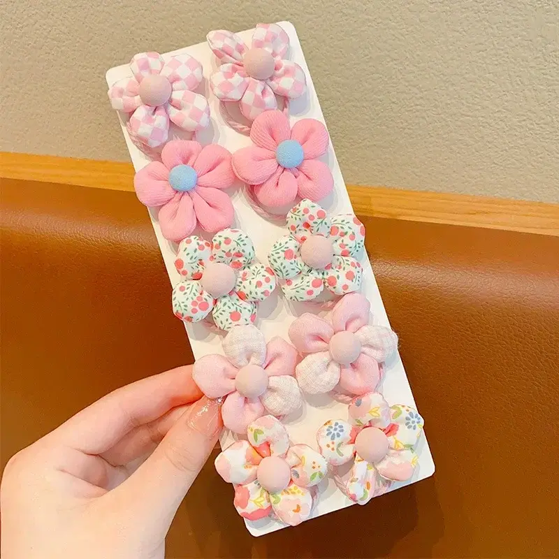 Thumbnail: Hand holding 10 cute Baby Girl Cute Colors Flower Hair Bands.