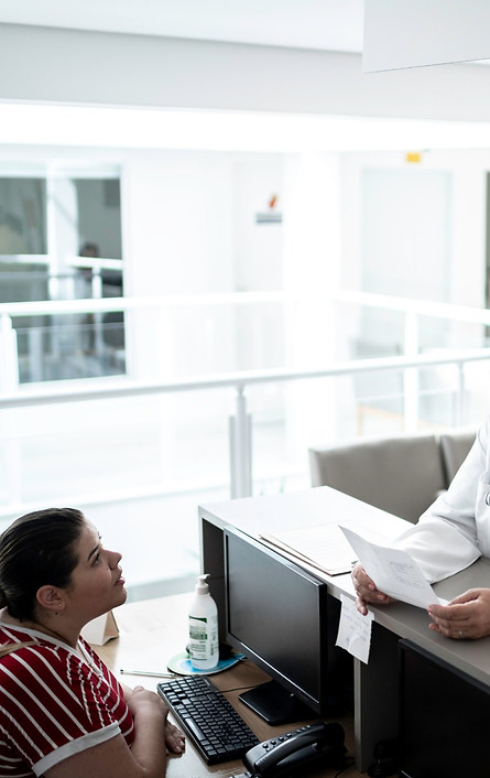 Krankenhaus bewachungs Mitarbeiter am Rezeption erteilt Informationen an Besuchern