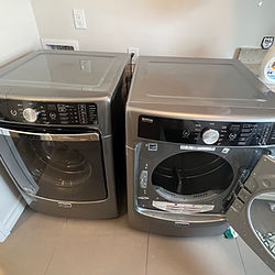 Expert technician fixing a washing machine's door seal to prevent leaks