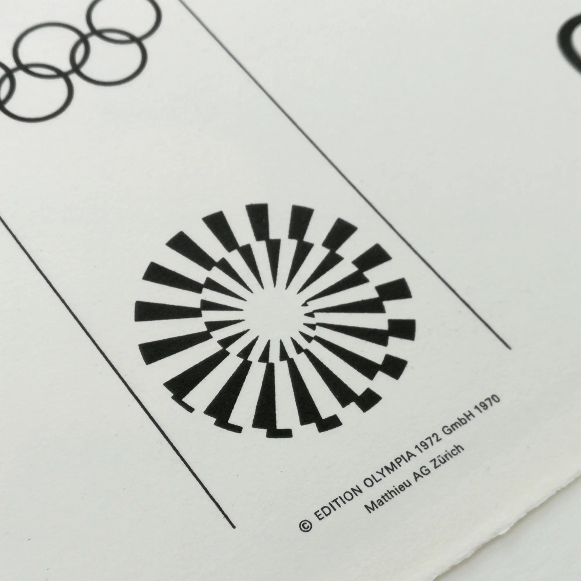 Black and white geometric patterns on paper; Olympic rings above a starburst design. Text reads: "EDITION OLYMPIA 1972 GmbH 1970."
