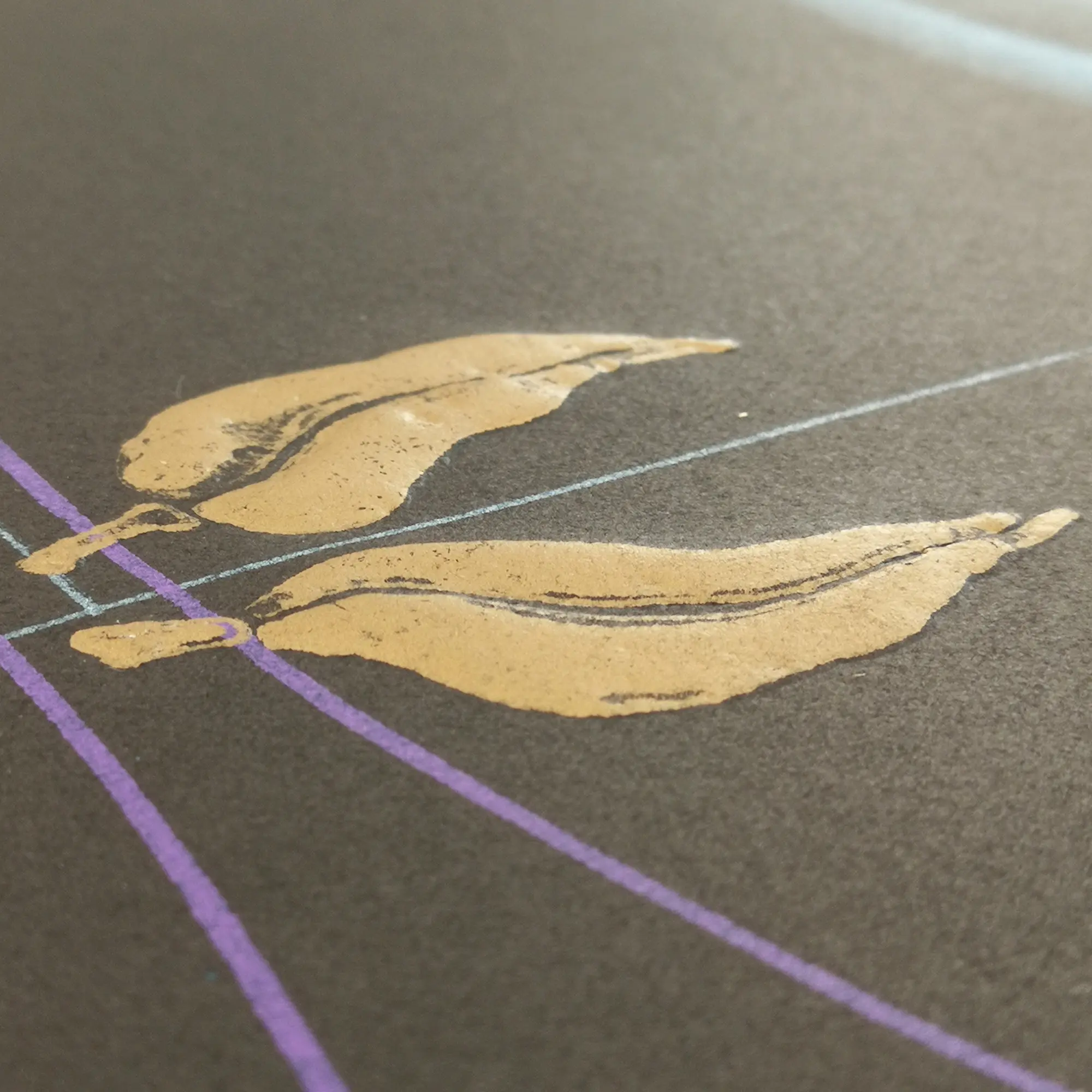 Gold leaves on a dark surface with intersecting blue and purple lines. Minimalist design with a calm, artistic feel.