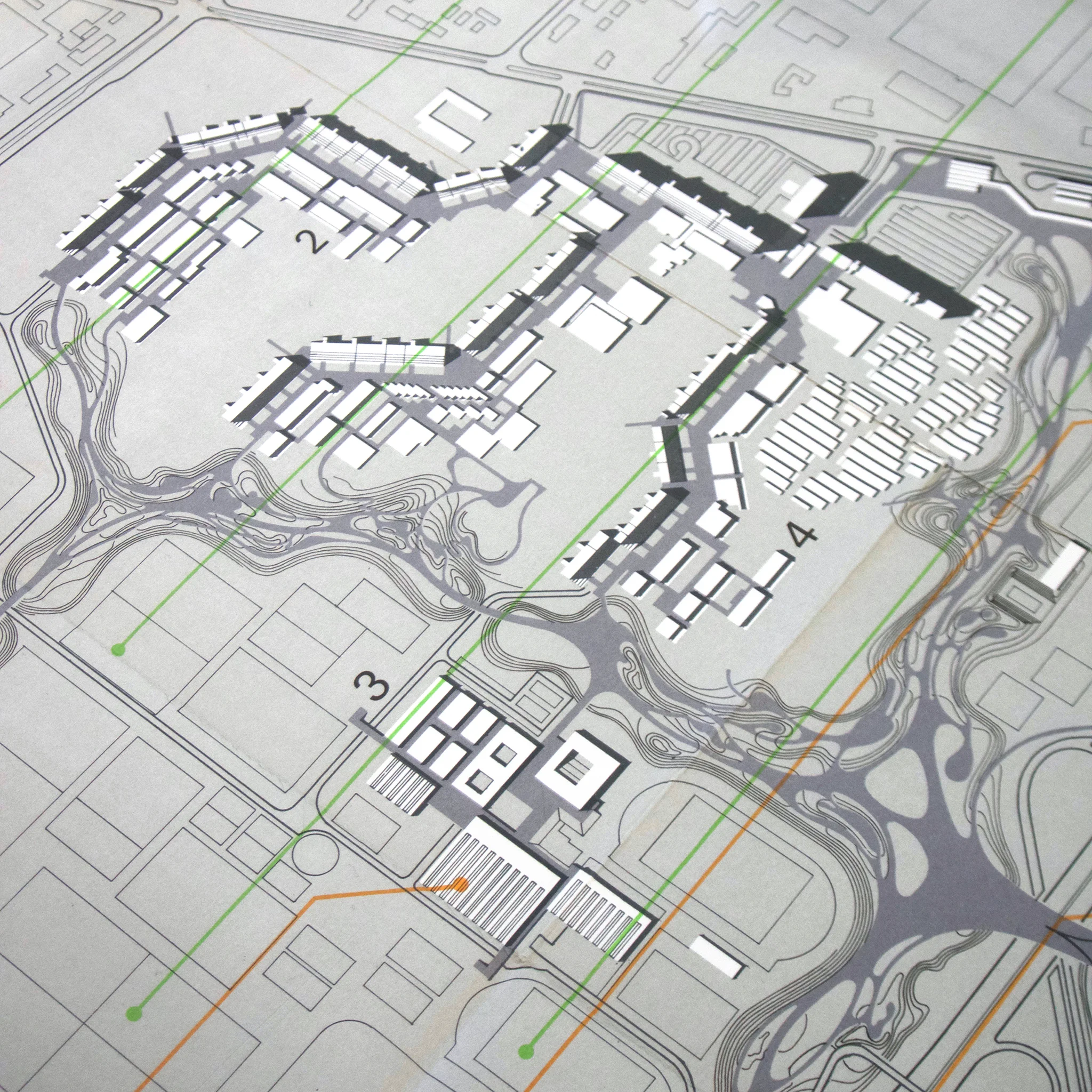 Architectural plan with numbered sections, grey and white buildings, curving lines, and green grid lines on a light background.