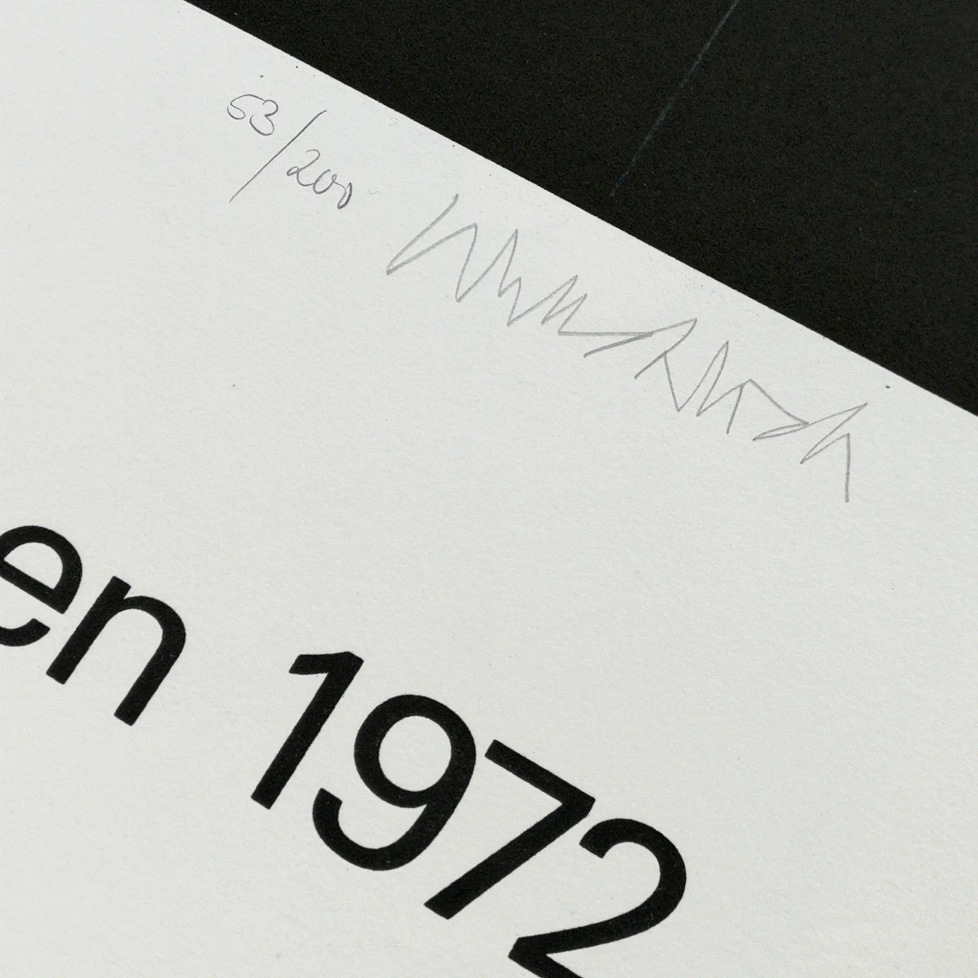Close-up of a numbered and signed print corner on white paper, featuring the partial text "en 1972" in bold black.