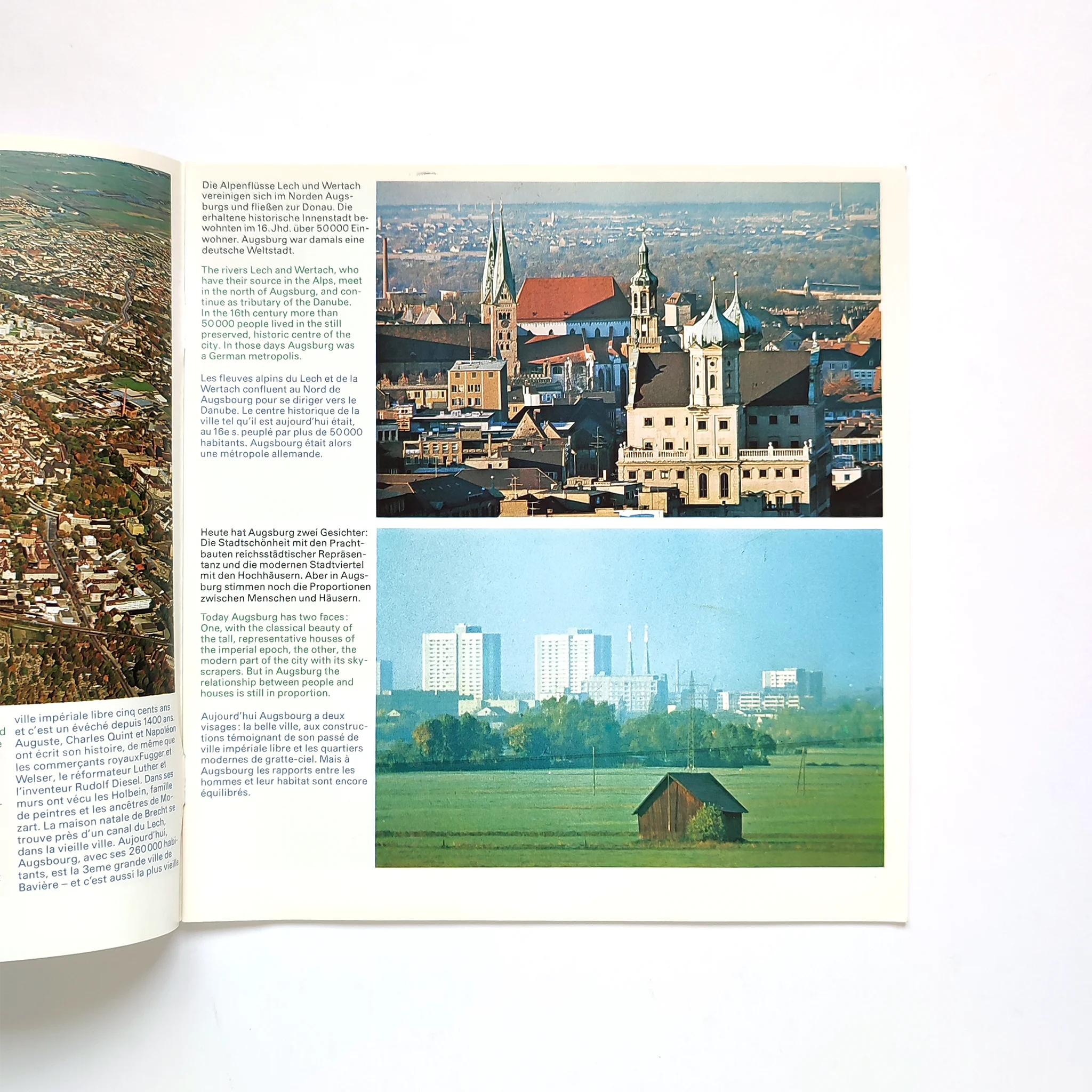 Open brochure with aerial views of Augsburg. Top image shows historic buildings and churches; bottom image shows modern buildings and green fields.