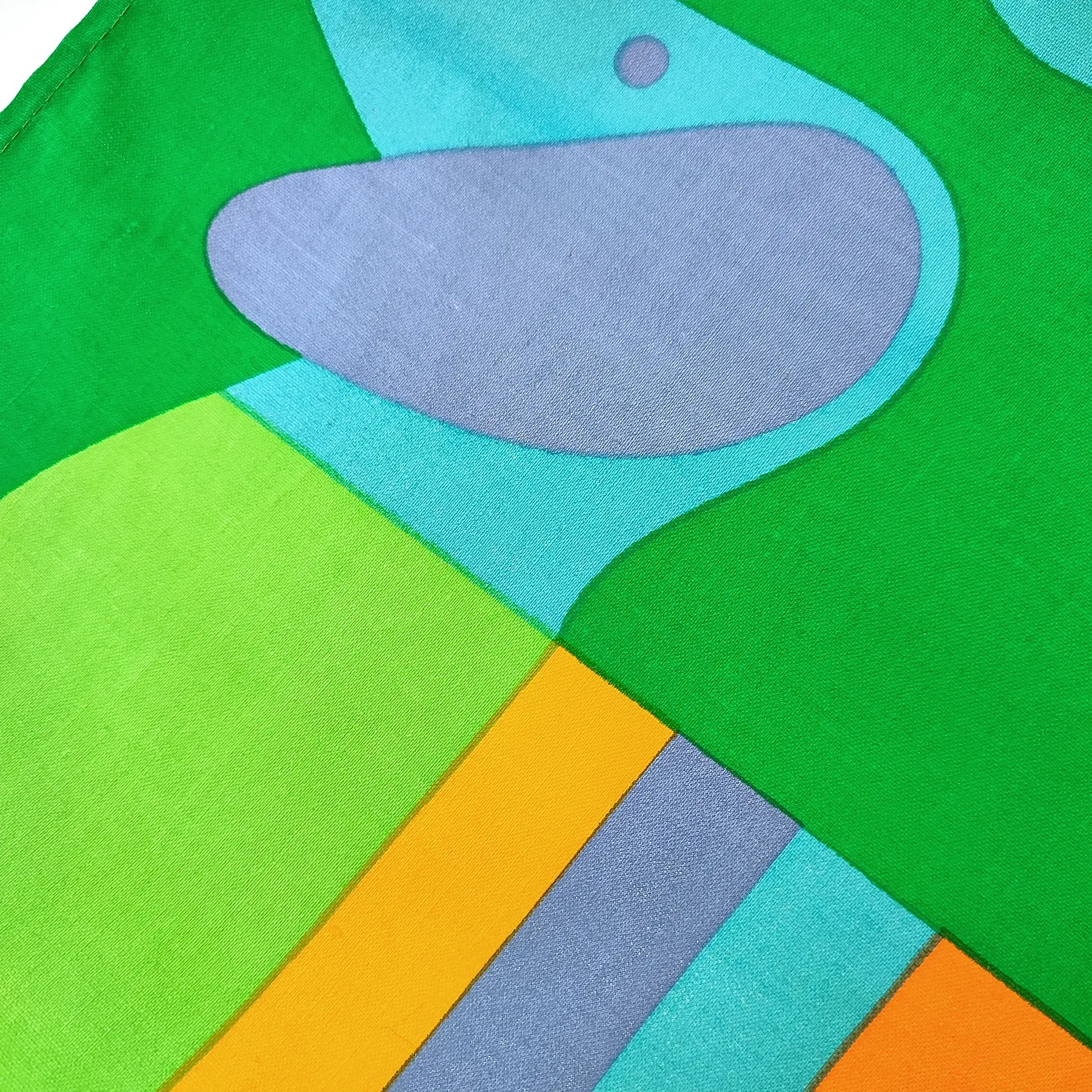 Abstract artwork with overlapping shapes in green, blue, gray, and orange. Bold geometric patterns create an energetic, vibrant design.