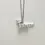 Thumbnail: A silver pendant version of Olympia Waldi with necklace