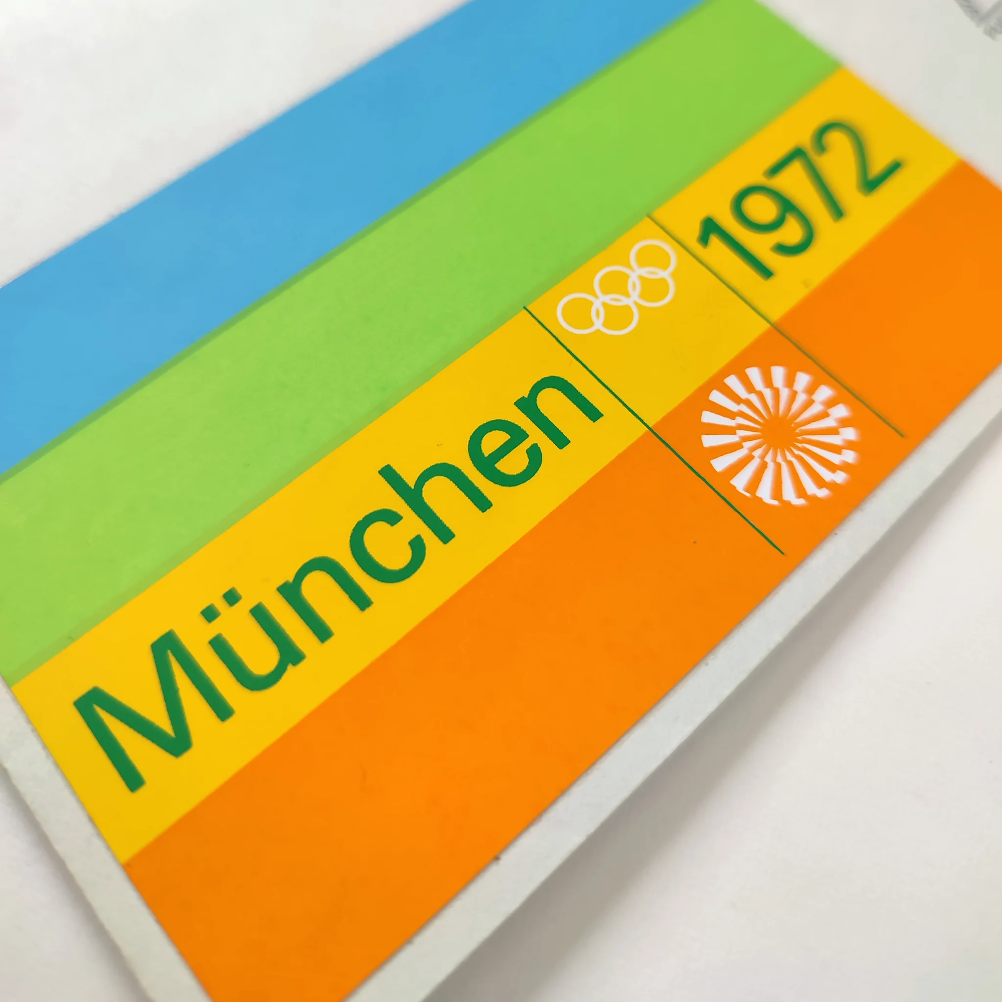 A detailed image of a colourful striped sticker with logo and München 1972 text