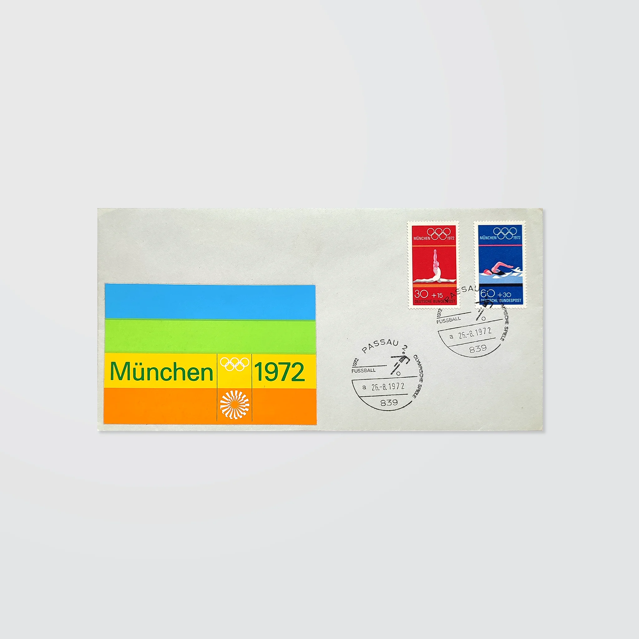 A stamped envelope with special postmarks and a colourful striped logo sticker for the Munich 1972 Olympics