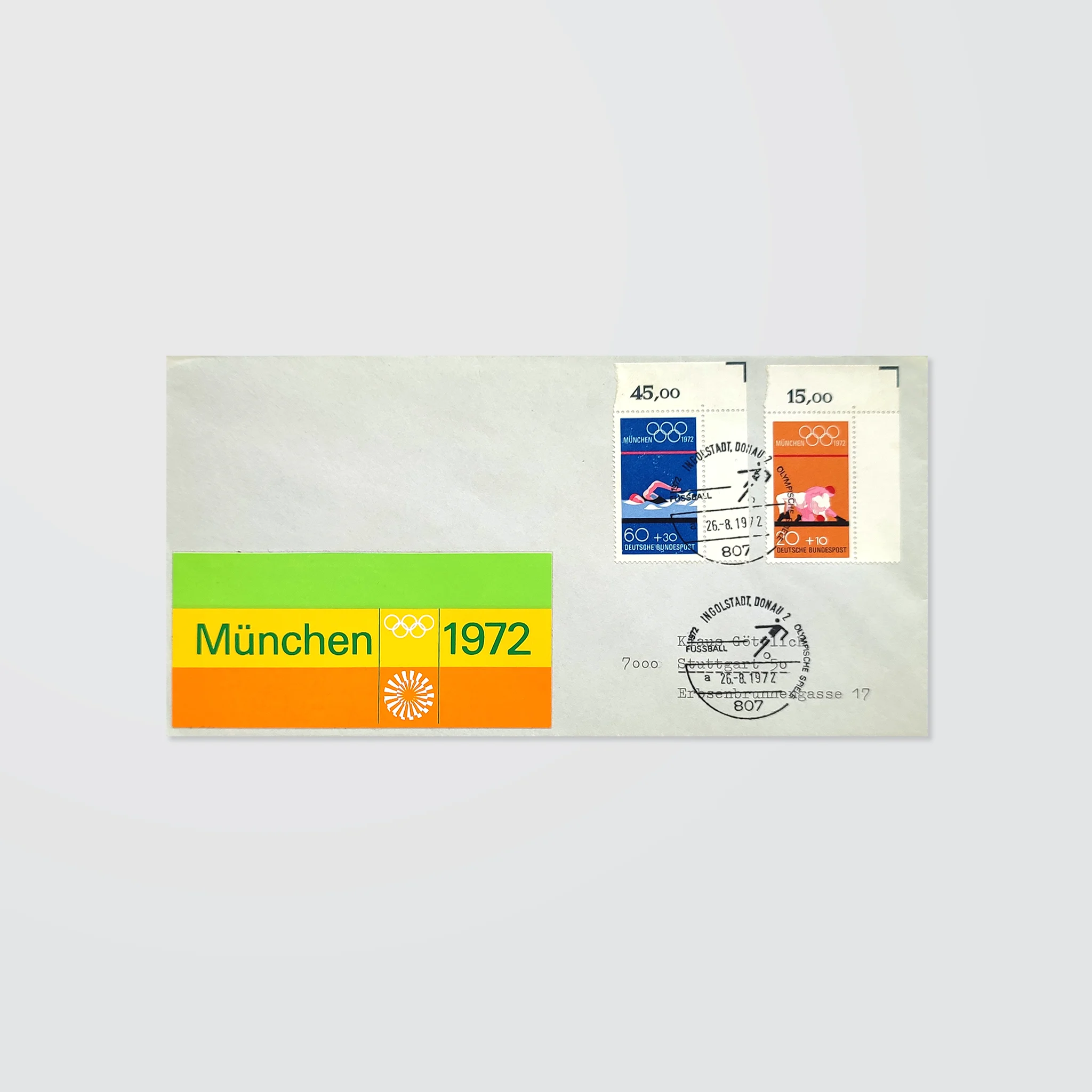 A stamped envelope with special postmarks and a colourful striped logo sticker for the Munich 1972 Olympics