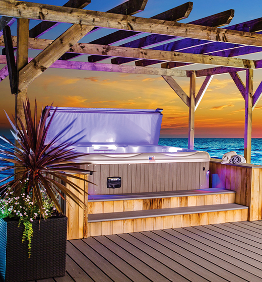 Best in Backyards' South Seas Series - 965L Deluxe Hot Tub featured under a pergola.