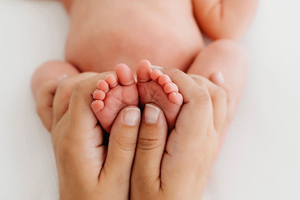 Close-up of newborn baby’s tiny hands and feet captured in a natural stylephotoshoot