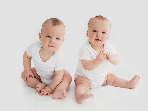 Twins playing during a photoshoot taken by Worthing photographer Kate Priest