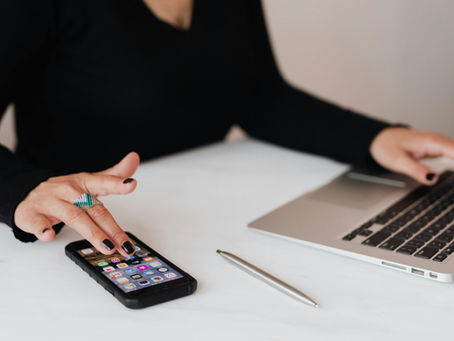 Businesswoman on phone and laptop.