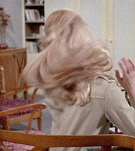 GIF of girl with long blonde hair.