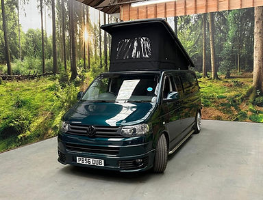 Green VW campervan with pop top lid open