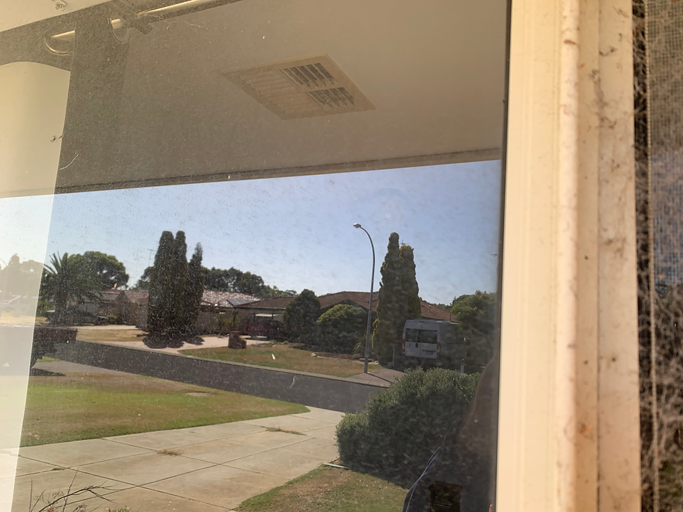 Dirt on the window glass and cobwebs on the window frame