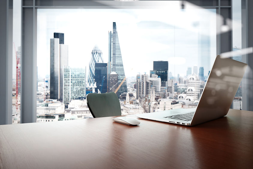 Office workplace with laptop and smart phone on wood table with london city background .jp