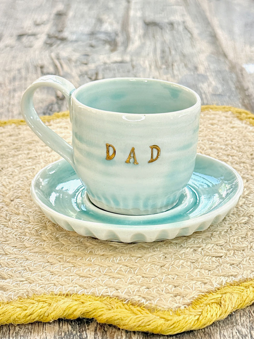 Thumbnail: beautiful hand thrown espresso cup and saucer in turquoise finish with gold lustre text detail