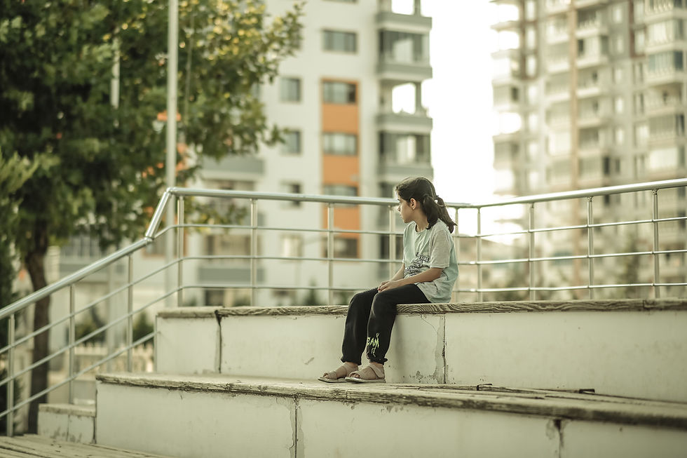 girl looking into the distance alone