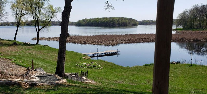 Scenic view of Cedar Lake with a dock and forested island.