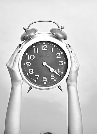 person holding red and beige twin bell a