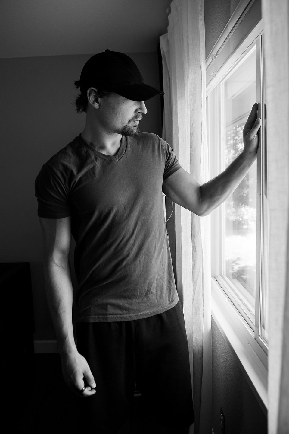 man looking out of window
