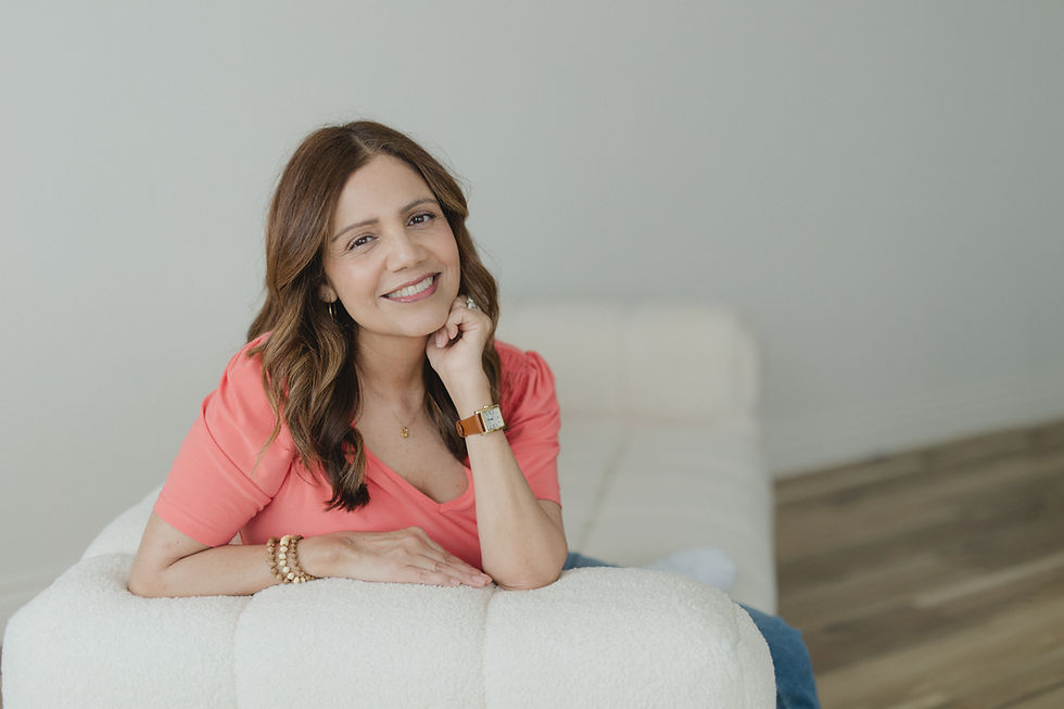 Yvonne Gonzalez, Licensed Educational Psychologist, smiling in a coral pink top while resting her chin on her hand.