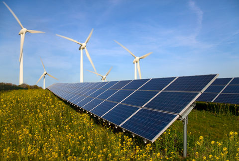 Wind turbines and solar panels in a field