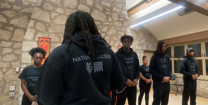 A group of dedicated individuals during a warrior training workshop, exemplifying commitment to personal and cultural growth.
