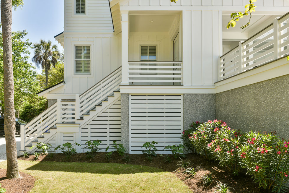 a white house with a balcony and stairs