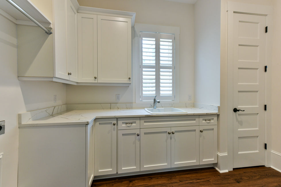 a kitchen with white cabinets and a sink