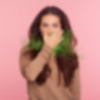 Woman covering her mouth with green gas effect to illustrate sulfur burps on GLP-1 medications