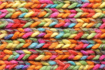 Abstract close-up image of colourful woven fabric representing interconnectedness and practice values