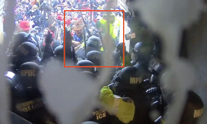 A Metropolitan Police Department officer raises her baton before striking Rosanne Boyland 