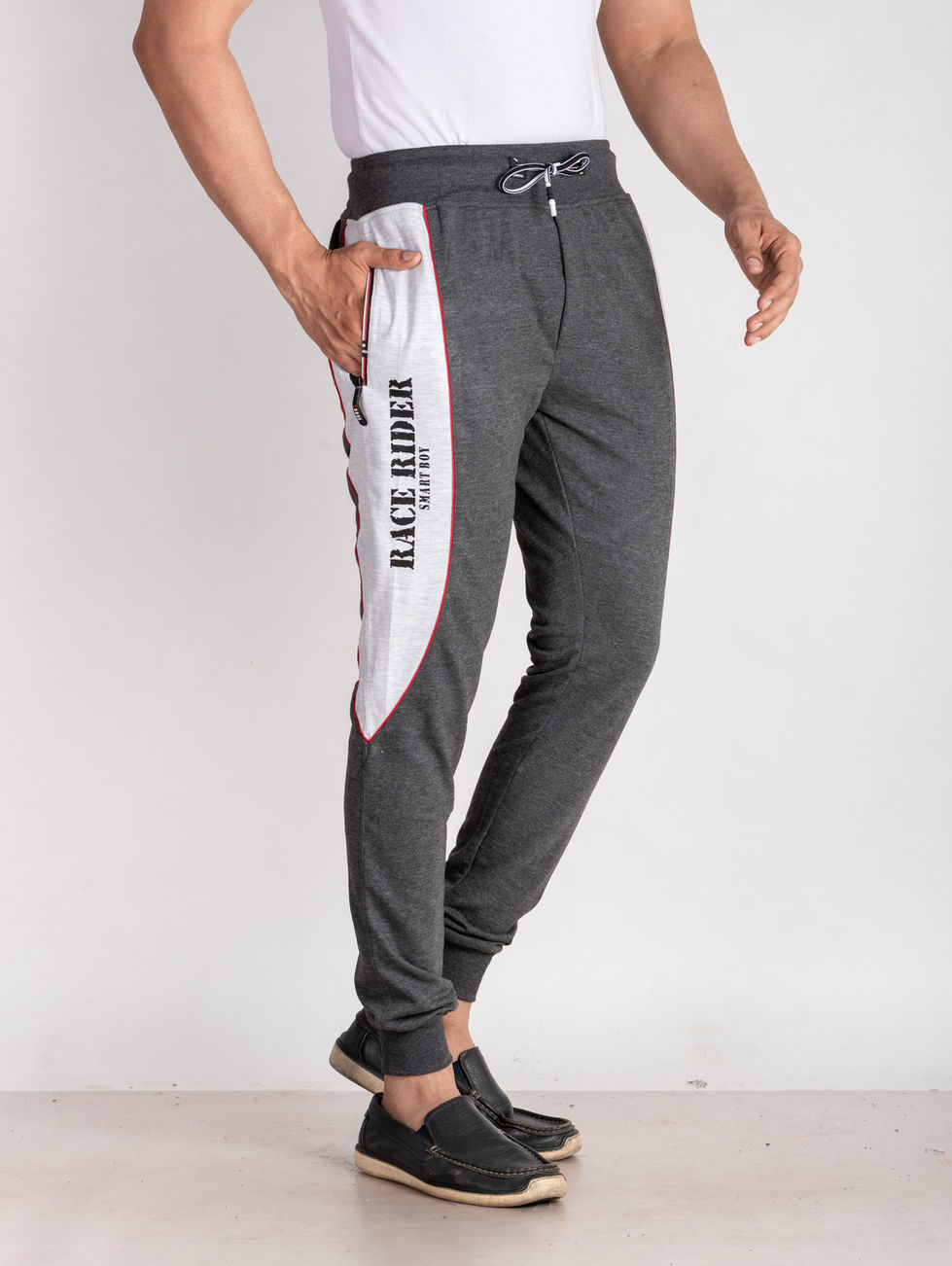 a man wearing a pair of race rider sweatpants