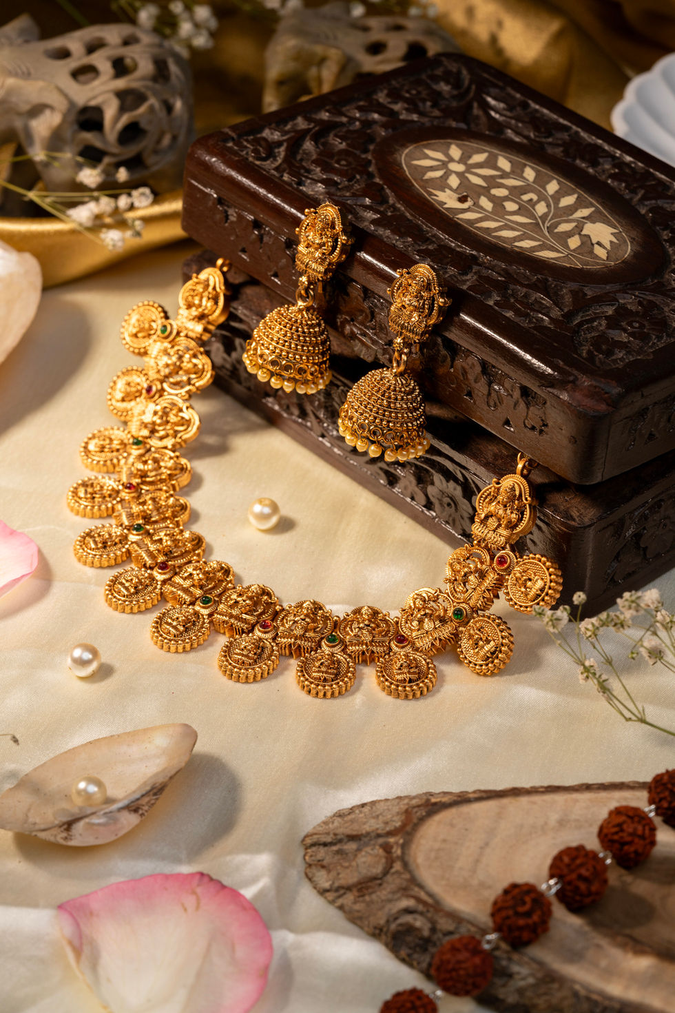 Intricate gold necklace and matching jhumka earrings