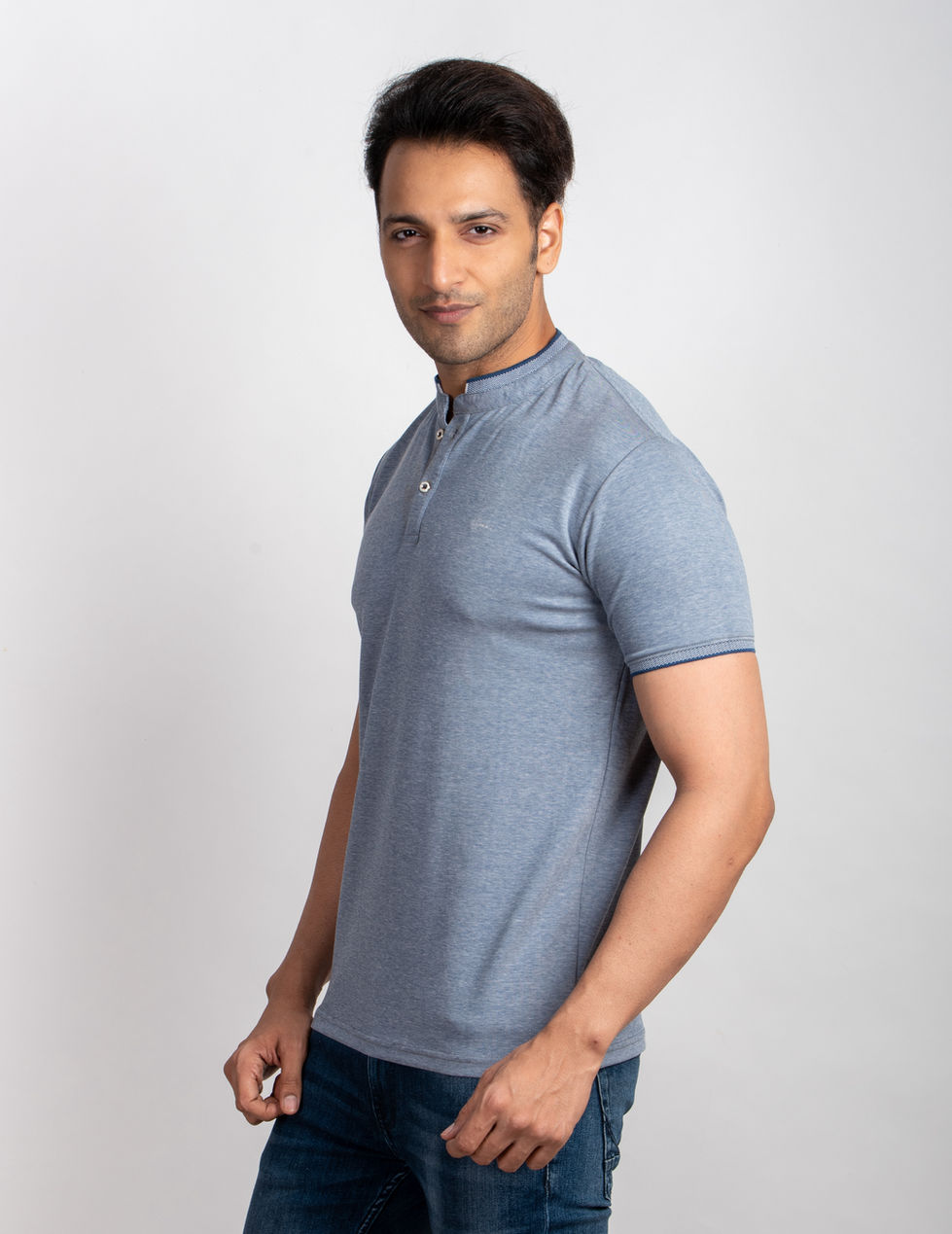 a man wearing a blue t-shirt with a mandarin collar
