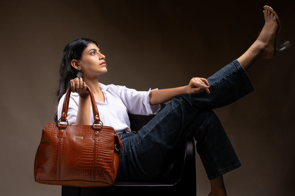 Woman holding a stylish brown textured handbag