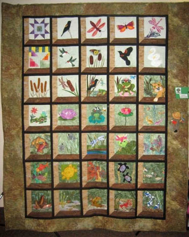 The Frog, Pond and Dragonflies quilt features quilt blocks of frogs, dragonflies and birds and was made by the Clark County Quilters to raise money for Babies in Need. 