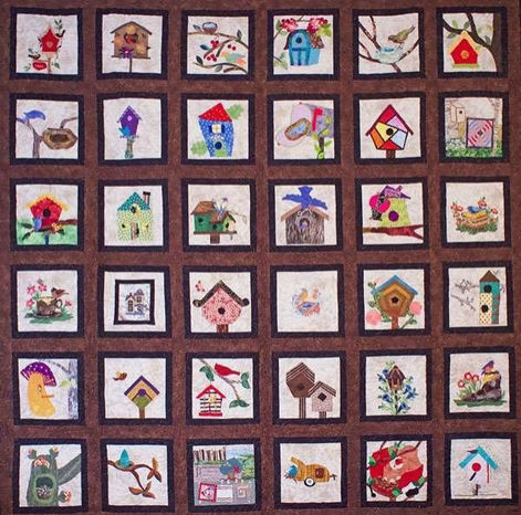 Quilt that features birdhouses surrounded by frames made by the Clark County Quilters