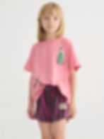 Child wearing pink and green striped shorts with a pink T-shirt.