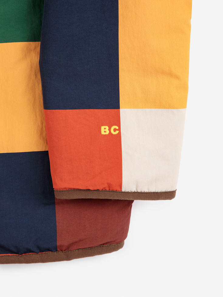Close-up of the “BC” logo on the multicolor fabric.