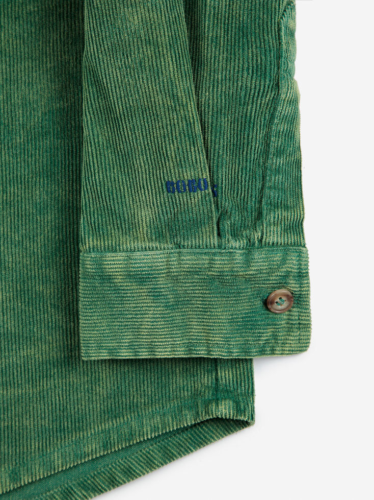 Detail of green corduroy sleeve cuff with button closure