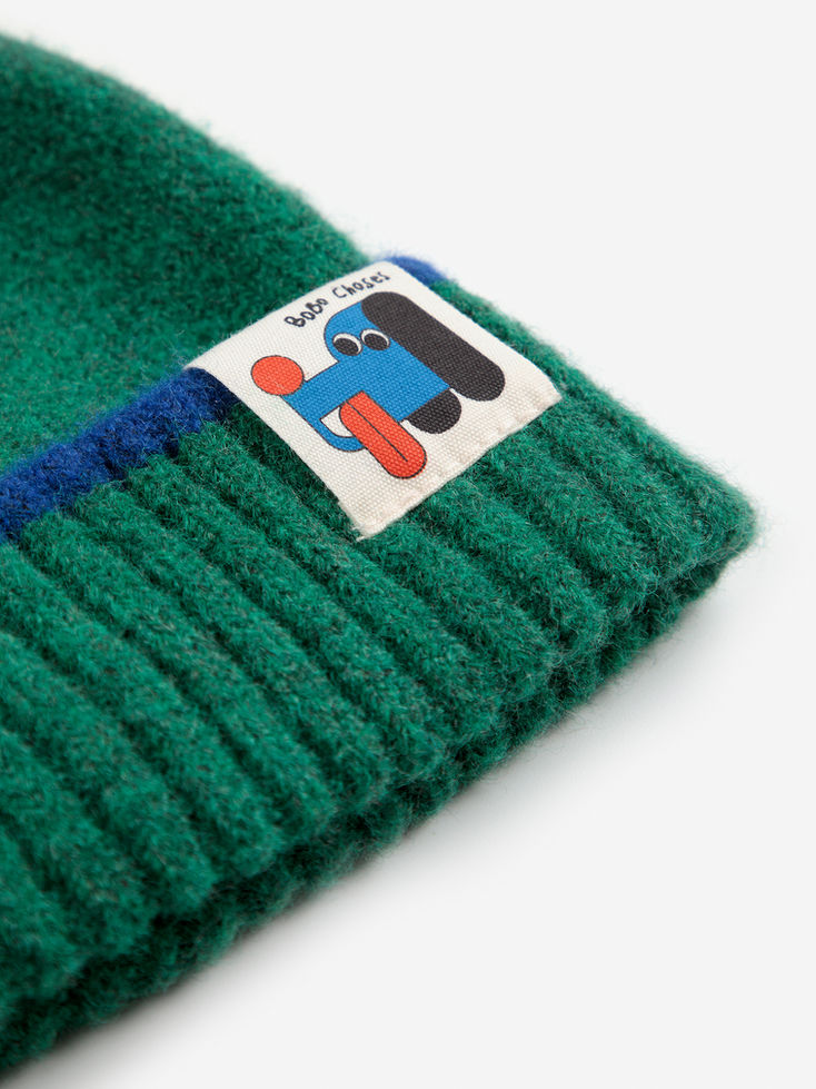 Close-up of Bobo Choses green beanie fabric and dog patch detail