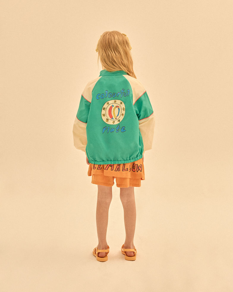 Back view of a child wearing the jacket, showing a large graphic on the back