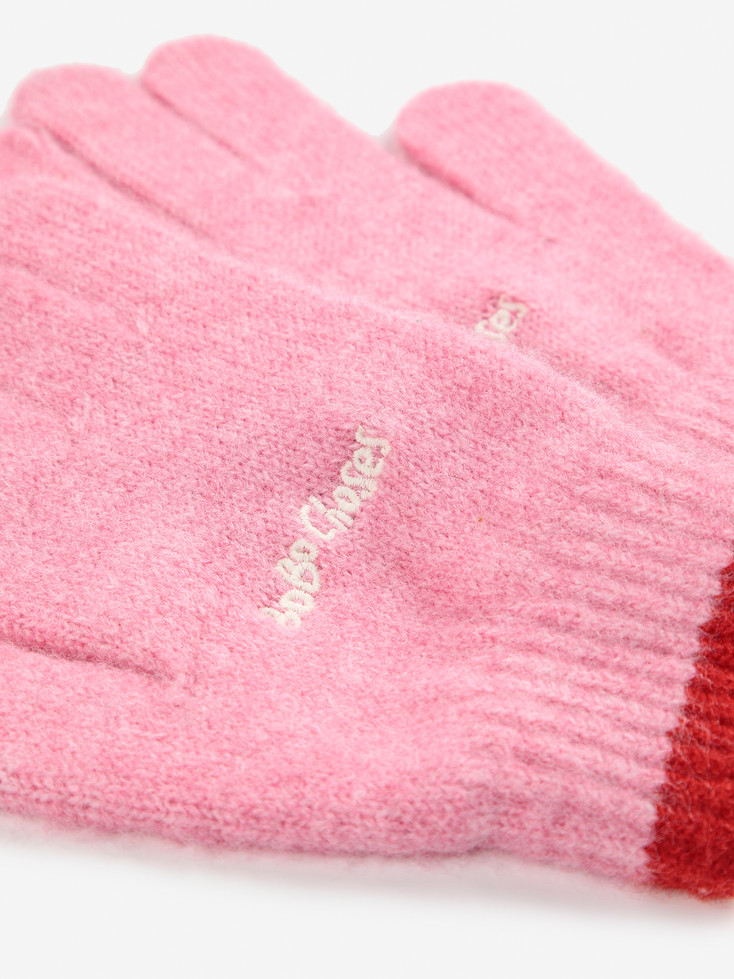 Close-up of Bobo Choses pink glove fabric and logo detail